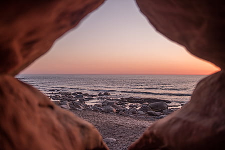 rock formation near sea during golden hour thumbnail