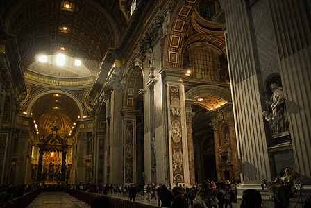 people standing inside brown and gray building thumbnail