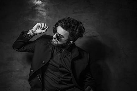 grayscale photography of man in black jacket wearing sunglasses thumbnail
