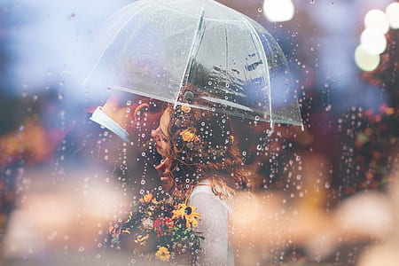 couple about to kiss under umbrella thumbnail