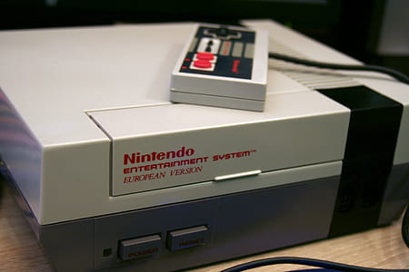 Nintendo NES console on top of brown wooden table thumbnail