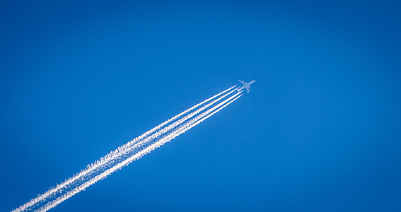 shallow focus photography of gray airplane on sky thumbnail