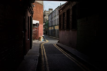concrete road between building during daytime thumbnail