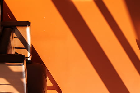 minimalist photography of orange painted wall with shadows thumbnail