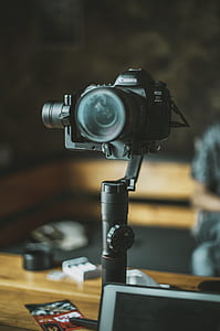 selective photo of black Canon EOS 5D camera with black camera stabilizer thumbnail