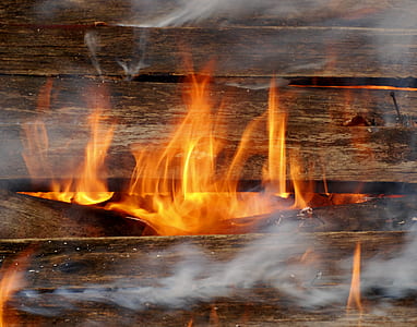 close-up photo of brown wooden plank with fire thumbnail