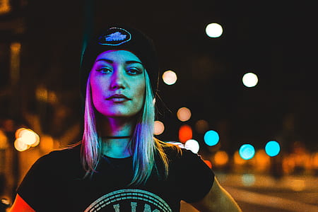 selective focus photography of woman standing near lights thumbnail