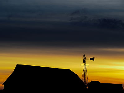 silhouette of house and mill during sunset thumbnail