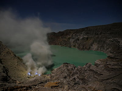 smoke coming in rocky mountain under starry night thumbnail