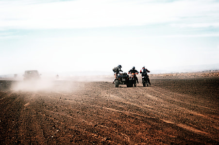 three men rides motorcycle and ATV on desert thumbnail