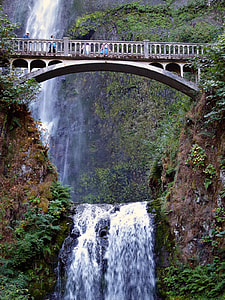 gray concrete bridge nearby waterfalls thumbnail