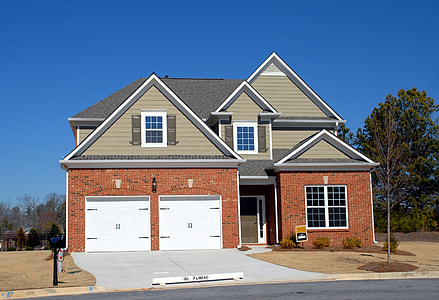 brown and beige house facade beside road thumbnail