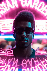 man wearing green crew-neck top and black sunglasses thumbnail