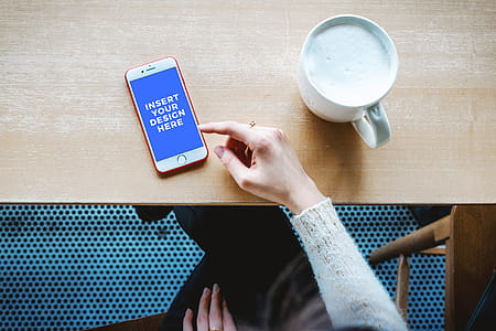 Free Mockup. Modern smartphone on the table with a hand of a woman in a cafe thumbnail