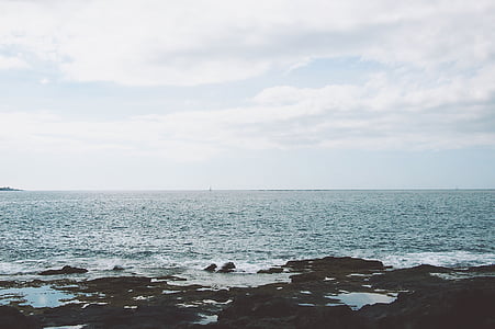 body of water and rock formations thumbnail