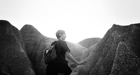 woman holding rock during daytime thumbnail