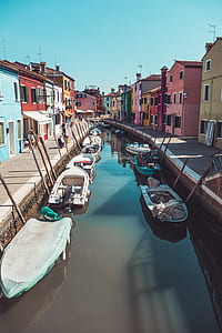 boat on body of water beside village thumbnail