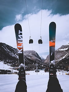 person wearing green-and-orange snow skis thumbnail