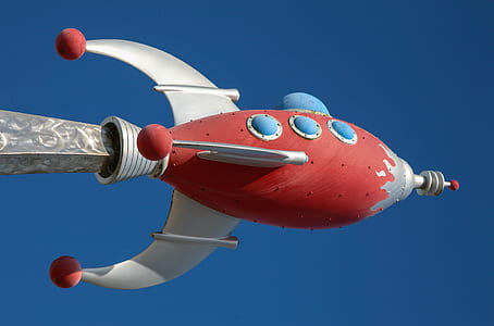 red and white space ship figurine at daytime thumbnail