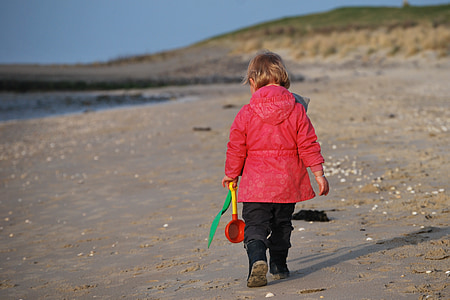 photo of girl walking on seashore thumbnail