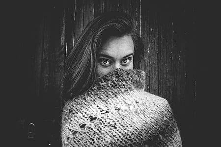 Grayscale Photo of Woman Covering Mouth With Knitted Textile thumbnail