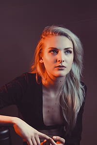 woman sitting while holding both hands thumbnail