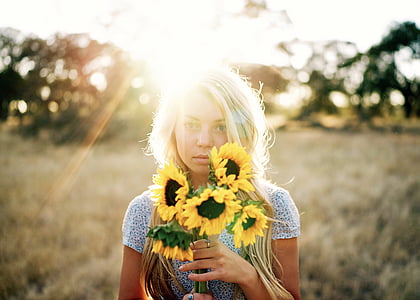 woman holding sunflower thumbnail