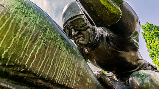 man wearing half-face helmet and aviator goggles statue thumbnail