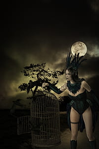 woman holding birdcage wallpaper thumbnail