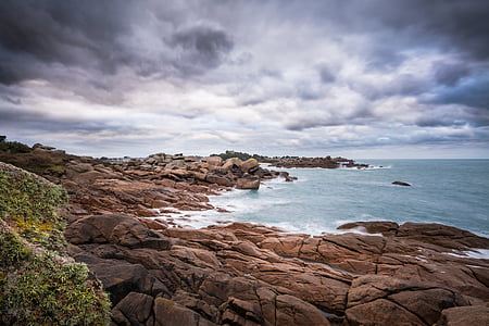 landscape photography body of water near rocks thumbnail