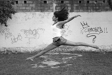 time lapse photography of woman jumping near white wall thumbnail
