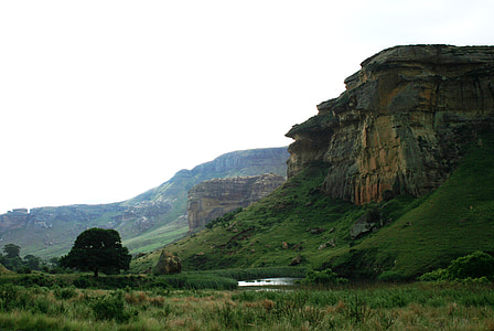 rock formation surrounded by grass field thumbnail