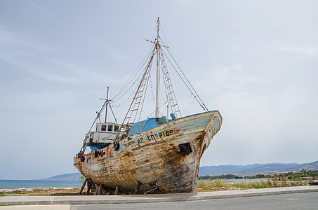 gray ship on seashore under gray sky thumbnail