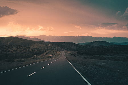 concrete road between mountains thumbnail