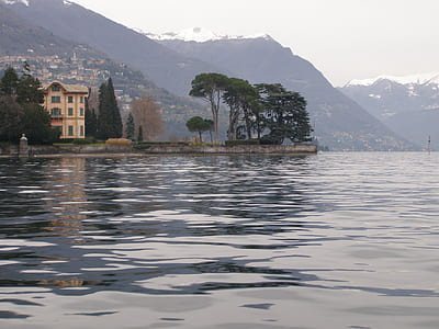 beige concrete house near body of water during daytime thumbnail