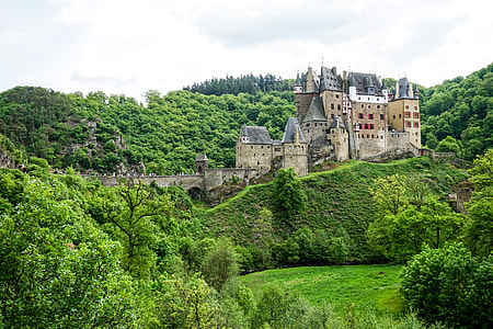 beige castle on top of green mountain thumbnail