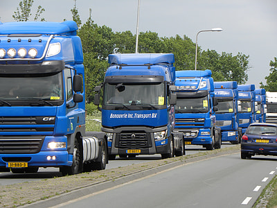 blue and black utility trucks on gray road during daytime thumbnail