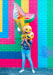 woman holding helium balloons during daytime thumbnail