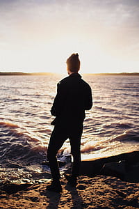 man standing near body of water thumbnail