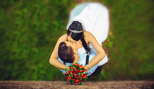 woman holding red rose bouquet while kissing man thumbnail