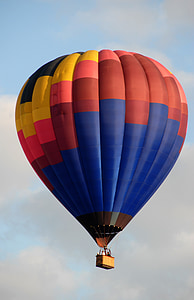 people riding red, yellow, and blue hot air balloon at daytime thumbnail