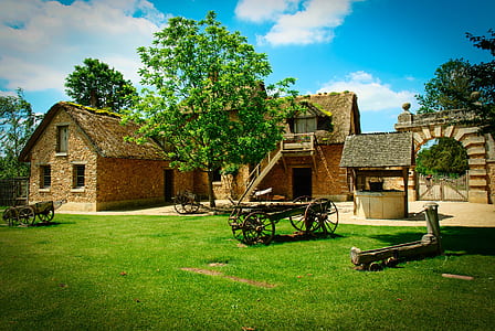 brown wagon beside brown house thumbnail