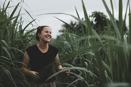 woman smiling surrounded by grasses thumbnail