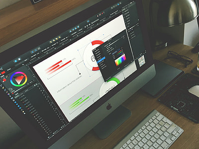 silver iMac with Magic keyboard and Magic mouse on desk inside room thumbnail
