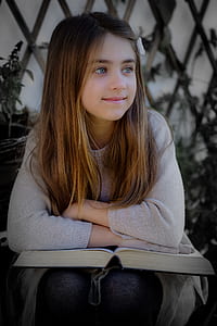 girl wearing sweater and leaning on the book thumbnail