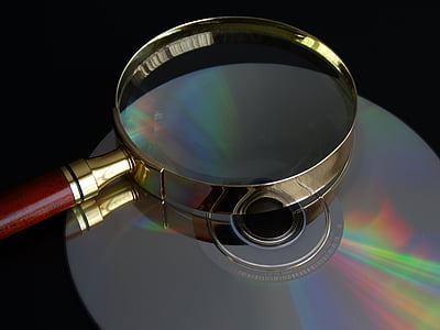 round silver magnifying glass on gray CD thumbnail