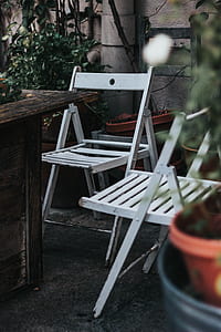 two white wooden folding chairs near table thumbnail