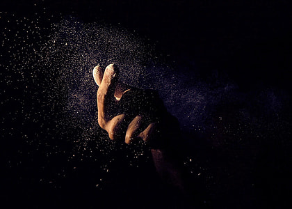 person's hand holding white sand photo thumbnail