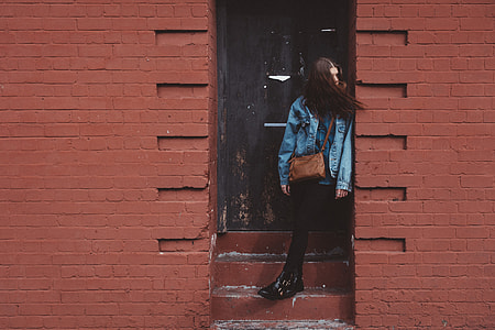 woman standing on stair while looking sideward thumbnail