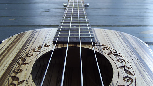 brown bass guitar placed on floor thumbnail
